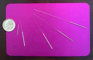 this shows the different sizes of acupuncture needles, and how small and fine they are, compared to the size of a dime. 