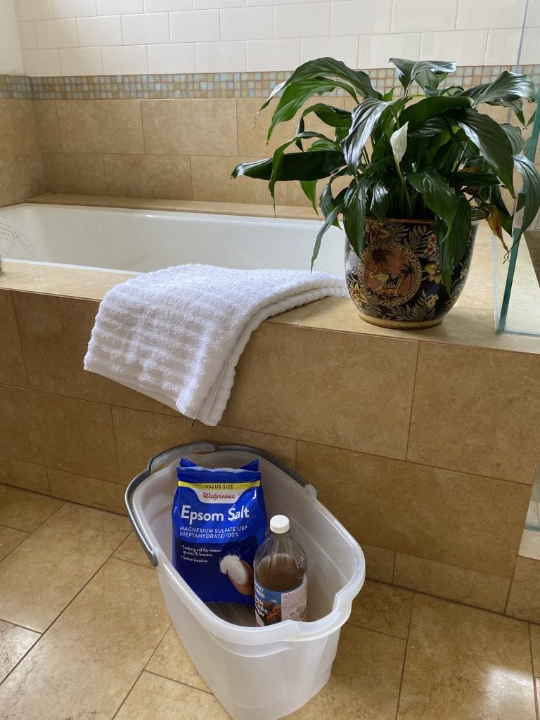 foot soaking supplies: bucket, salt, vinegar, soft towel