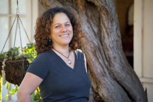 portrait photo of Rebecca Zendejas, an artist who creates personal altars called "zendohous"