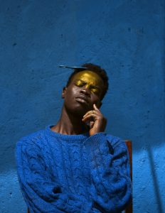 Man thinking, golden light on his forehead and eyes.