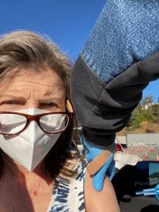 woman receiving Moderna Covid-19 vaccine at Dodger Stadium