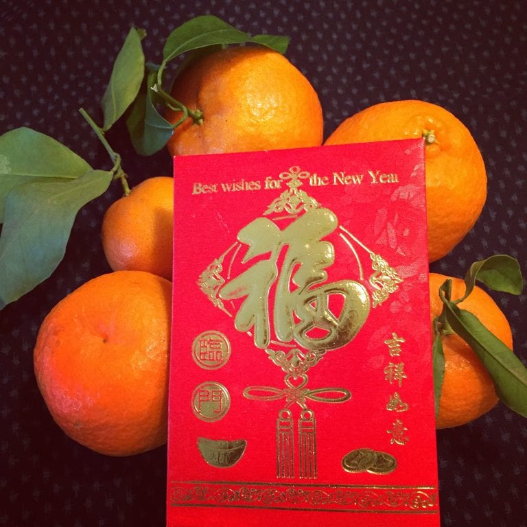 tangerines with stems and leaves represent good luck for Lunar New Year